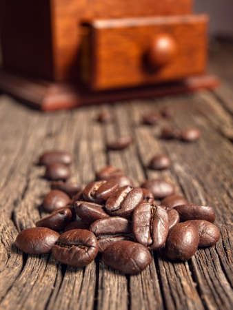Coffee beans on an old wooden tableの写真素材