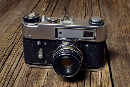 Vintage camera on a wooden tableの写真素材