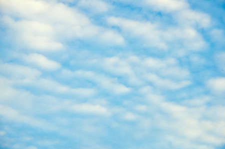 blue sky background with clouds on old paperの写真素材