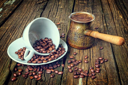 coffee Cup and coffee beans on wooden tableの写真素材