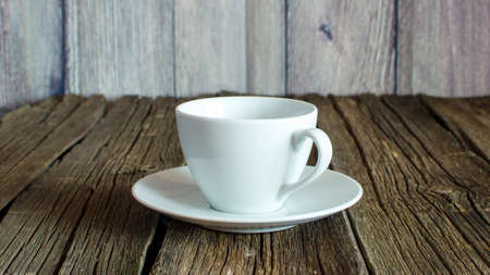 White coffee cup on a wooden tableの写真素材