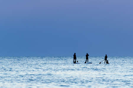 Stand Up Paddling. Silhouette at sunset.の写真素材