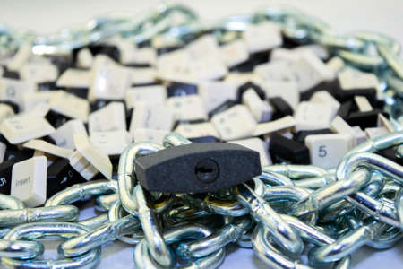 censorship, restrictions and restrictions on the Internet. concept, keys from computer keyboards in a chained space and under lock and keyの写真素材