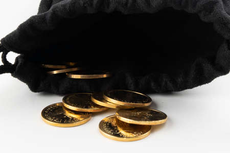 coins worth 1 dollar pour out of the bag, White backgroundの写真素材