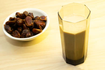 Hushaf - date milk, traditional Ramadan dish, cooking, ingredients, glass with date milk - khushaf and dish with dates are on the tableの写真素材