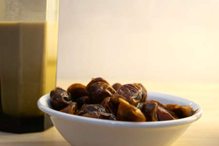 Hushaf - date milk, traditional Ramadan dish, cooking, ingredients, glass with date milk - khushaf and dish with dates are on the tableの写真素材