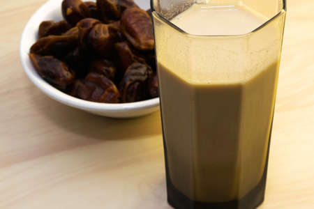Hushaf - date milk, traditional Ramadan dish, cooking, ingredients, glass with date milk - khushaf and dish with dates are on the tableの写真素材