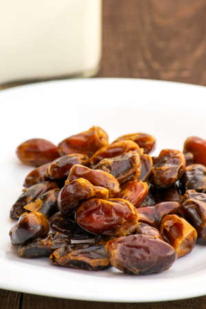 Hushaf - date milk, a traditional dish to Ramadan, cooking, ingredients, dates in the plate and milk in bottles are on the tableの写真素材