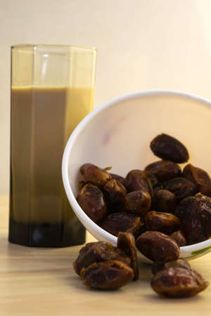 Hushaf - date milk, traditional Ramadan dish, cooking, ingredients, glass with date milk - khushaf and dish with dates are on the tableの写真素材