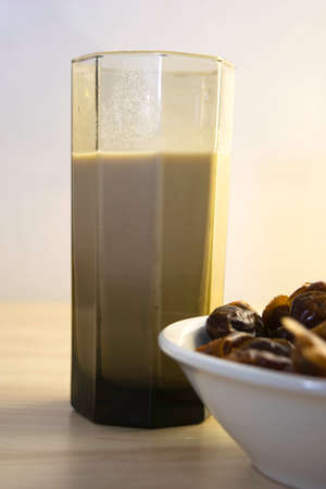 Hushaf - date milk, traditional Ramadan dish, cooking, ingredients, glass with date milk - khushaf and dish with dates are on the tableの写真素材