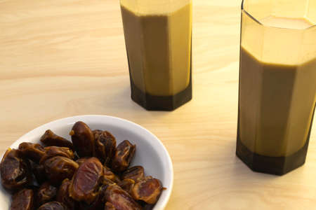 Hushaf - date milk, traditional Ramadan dish, cooking, ingredients, two glasses with date milk - Hushaf and the dish with dates are on the tableの写真素材