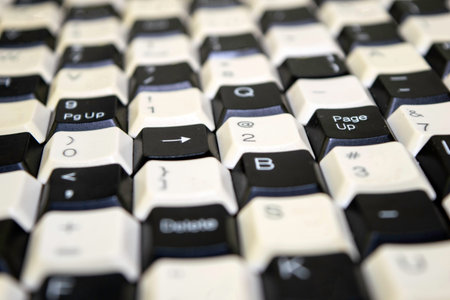 a set of keys from old computer keyboards laid out on the table in a staggered manner