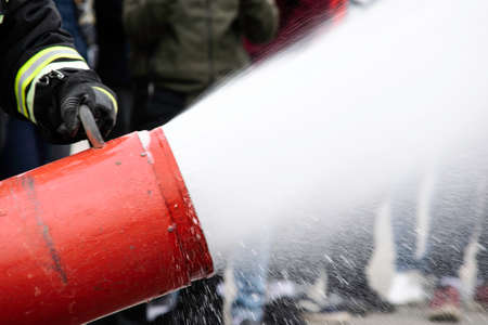 Supply of foam from the foam generator, fire extinguishing foam flies from the foam generator, which keeps the fireman in combat clothingの写真素材