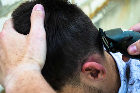 the barber cuts the guy off with a clipperの写真素材