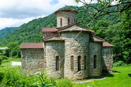 10th century ancient Christian church, Nizhnearhizy temples, Northern Zelenchuk temple, ancient stone temple among mountains and vegetationの写真素材
