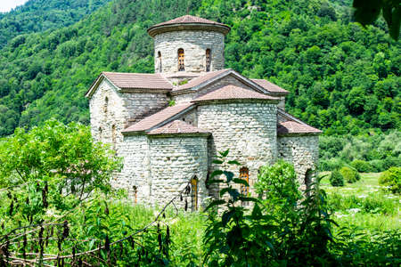 10th century ancient Christian church, Nizhnearhizy temples, Middle Zelenchuksky temple, ancient stone temple among mountains and vegetationの写真素材