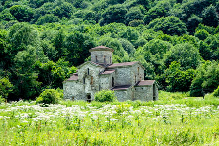 10th century ancient Christian church, Nizhnearhizy temples, Middle Zelenchuksky temple, ancient stone temple among mountains and vegetationの写真素材