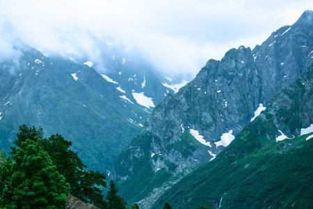The mountain landscape - mountains forest, rocks glaciers snow clouds, Dombay, Karachay-Cherkessia, Russiaの写真素材