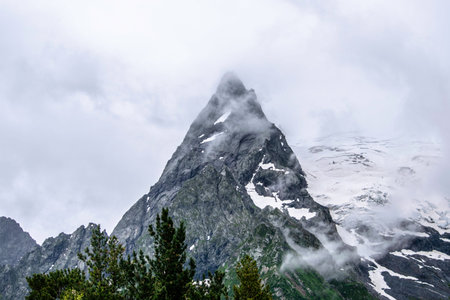 The mountain landscape - mountains forest, rocks glaciers snow clouds, Dombay, Karachay-Cherkessia, Russiaの写真素材