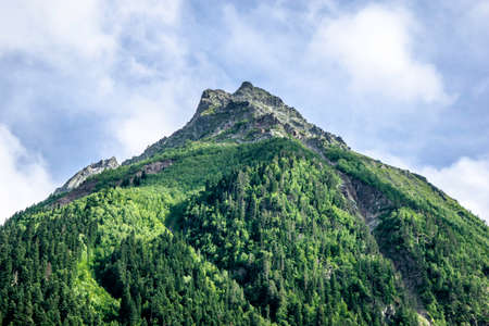mountain landscape - mountains forest, rocks glaciers snow clouds, Dombay, Karachay-Cherkessia, Russiaの写真素材