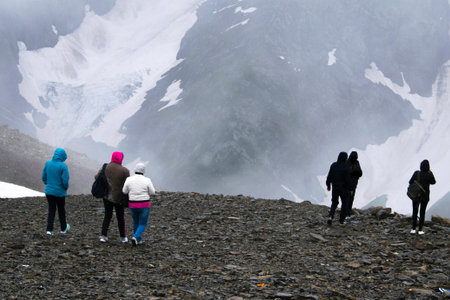 tourists stand over a precipice high in the mountains