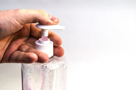 man holds in his hand a bottle of liquid soap close-up