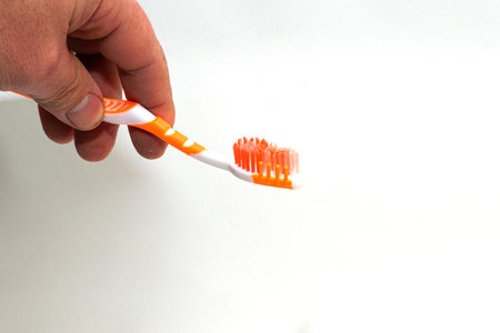 toothbrush in a man's hand on a white background