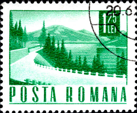 02.09.2020 Divnoe Stavropol Territory Russia postage stamp Romania 1967 Transport Communication mountain landscape with the road and the foreground in greenのeditorial素材