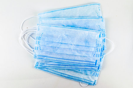 stack of medical hygiene masks on a white background