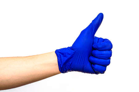 hand in blue rubber protective medical surgical glove on a white background hand clenched fist thumb raised upの写真素材
