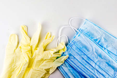 protective hygiene masks and gloves on a white background top viewの写真素材