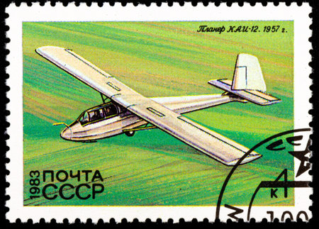 05 20 2020 Divnoe Stavropol Territory Russia postage stamp USSR 1983 History of Soviet Gliders Glider KAI-12 1957, Simonov flying against a green fieldのeditorial素材