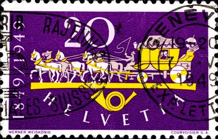 02 10 2020 Divnoe Stavropol Territory Russia postage stamp Switzerland 1949 The 100th Anniversary of the Swiss Post Mailcoach and postal hornのeditorial素材