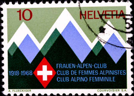 02 08 2020 Divnoe Stavropol Territory Russia postage stamp Switzerland 1968 Events 50th anniversary. of the swiss women s alpine club: 1918-1968 Mountains and club's emblem Stylized mountains club badgeのeditorial素材