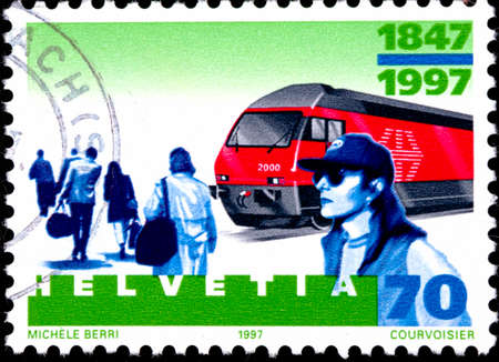 02 08 2020 Divnoe Stavropol Territory Russia the postage stamp Switzerland 1997 The 150th Anniversary of the Swiss Railways 1847-1997 Locomotive 2000 1990 train and passengersのeditorial素材