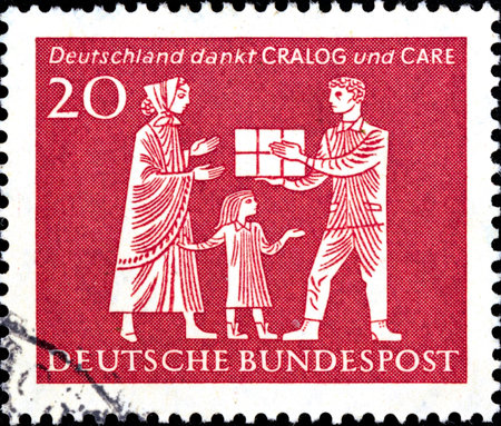 02 10 2020 Divnoe Stavropol Territory Russia Germany postage stamp 1963 CRALOG and CARE, Helping Organizations Mother and child receiving gift parcelのeditorial素材