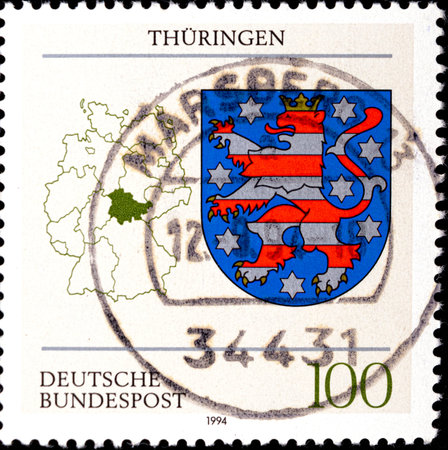 02 08 2020 Divnoe Stavropol Territory Russia postage stamp Germany 1994 German Constituent States Th ringen Coat of Arms of the Federal States of Germany Thuringia Coat of Arms blue coat of arms with a striped lion.のeditorial素材