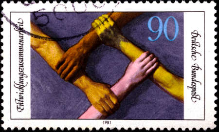 02 08 2020 Divnoe Stavropol Territory Russia Germany postage stamp 1981 Co-operation with Developing Countries Arms of different Races forming Squareのeditorial素材