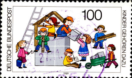 02 11 2020 Divnoe Stavropol Territory Russia postage stamp Germany 1989 Campaigns - Don't Forget the Children Children Building Houseのeditorial素材
