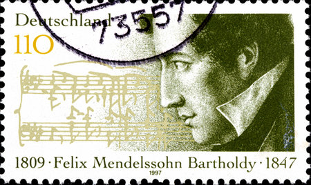 02 10 2020 Divnoe Stavropol Territory Russia postage stamp Germany 1997 The 150th Anniversary of the Death of Felix Mendelssohn Batholdy 1809-1847, Composer and music score portrait on the background of musicのeditorial素材