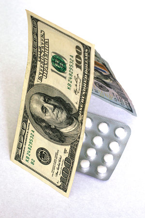 concept business on drugs a blister with pills in a house made of hundred dollar bills. High quality photoの写真素材