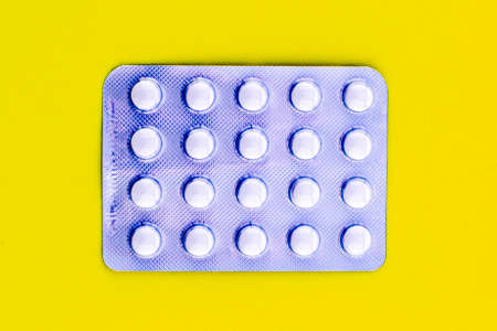blister with tablets on a yellow background. High quality photoの写真素材