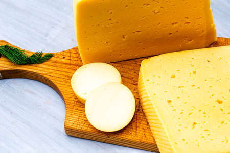 pieces of cheese on a wooden cutting board. High quality photoの写真素材