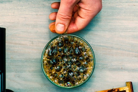 cup of coffee in the hand of a man close-up view from above High quality photo
