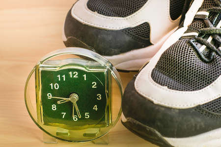 the concept of a healthy lifestyle watch stand side by side with sneakers. High quality photoの写真素材