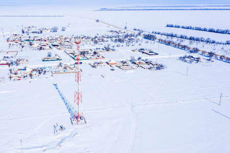 cell tower in a field near the village in winter view from the throne. High quality photoの写真素材