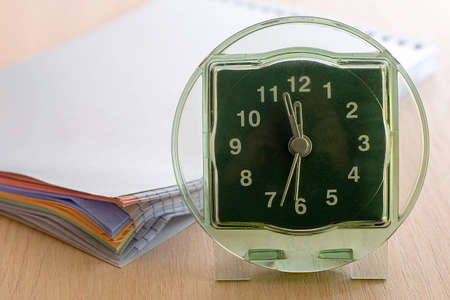 the clock is on the shelf next to it is a notebook-a diary for writing. High quality photoの写真素材