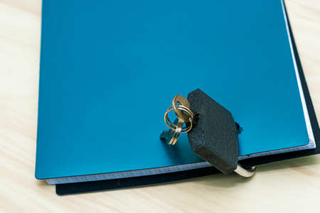 the concept of information protection a closed lock with keys hangs on the notebook for notesの写真素材