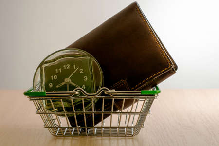 my wallet and watch are in the shopping basket concept shopping time. High quality photoの写真素材
