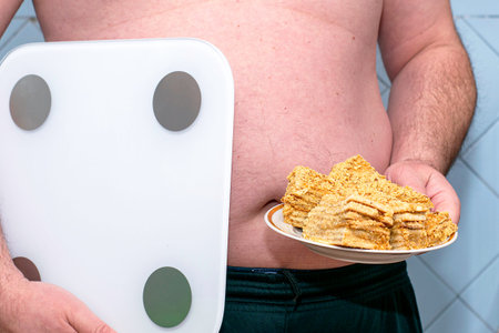 a fat man holds a scale in his hands in the other hand a plate of cakes concept diet proper...